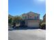 Charming two-story home featuring stucco siding, a tile roof, a two-car garage, and manicured landscaping at 8977 Melridge Rd, Las Vegas, NV 89148