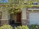 Inviting home entrance showcasing a brick facade, a covered porch, and a decorative front door at 8977 Melridge Rd, Las Vegas, NV 89148