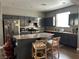 Open kitchen with granite counters, island with seating, and stainless steel appliances at 8977 Melridge Rd, Las Vegas, NV 89148