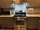 Modern kitchen features stainless steel range, sleek backsplash, and ample cabinet space at 8977 Melridge Rd, Las Vegas, NV 89148