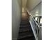 Wood staircase with white railing leads to the second floor of the home at 8977 Melridge Rd, Las Vegas, NV 89148