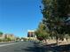 This street view features lush green trees, a building, and a sidewalk at 8977 Melridge Rd, Las Vegas, NV 89148