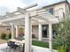 Picturesque backyard showcasing a covered patio, lush greenery, and outdoor dining area at 933 Hunter Shores Ave, North Las Vegas, NV 89084