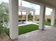 Outdoor entertaining space featuring a pergola, artificial grass, and a dining area at 933 Hunter Shores Ave, North Las Vegas, NV 89084