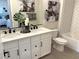 A modern bathroom boasts a double vanity, white cabinets, and updated fixtures at 933 Hunter Shores Ave, North Las Vegas, NV 89084