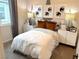 A cozy bedroom with a window view, modern décor and matching nightstands at 933 Hunter Shores Ave, North Las Vegas, NV 89084