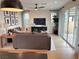 Cozy living room with a comfortable gray sofa, hardwood floors, and natural lighting at 933 Hunter Shores Ave, North Las Vegas, NV 89084