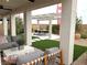 Relaxing covered patio with comfortable seating, a modern coffee table, and a view of the backyard at 933 Hunter Shores Ave, North Las Vegas, NV 89084