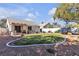 Spacious backyard with manicured lawn, garden areas, and covered patio at 9562 Collinsleap Ct, Las Vegas, NV 89123