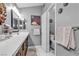 Bathroom featuring double sinks, quartz countertop, and adjacent toilet room at 9562 Collinsleap Ct, Las Vegas, NV 89123