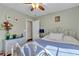 Comfortable bedroom with a ceiling fan, dresser, carpet, and a quaint bed frame at 9562 Collinsleap Ct, Las Vegas, NV 89123
