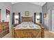 Large bedroom with ceiling fan, dresser, bed, and hardwood floors at 9562 Collinsleap Ct, Las Vegas, NV 89123