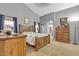 Spacious bedroom with a vaulted ceiling, bed, dresser, and ample natural light at 9562 Collinsleap Ct, Las Vegas, NV 89123