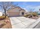 Charming single-story home features a neutral exterior and well-maintained landscaping at 9562 Collinsleap Ct, Las Vegas, NV 89123