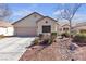 Charming single-story home features a neutral exterior, a two-car garage and manicured landscaping at 9562 Collinsleap Ct, Las Vegas, NV 89123