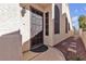 Inviting entryway with a decorative security door, lush landscaping, and textured walls at 9562 Collinsleap Ct, Las Vegas, NV 89123