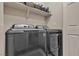 Laundry room features new front-loading washer and dryer beneath shelf space at 9562 Collinsleap Ct, Las Vegas, NV 89123