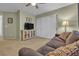 Well-lit living room with carpet, a comfortable couch and a ceiling fan at 9562 Collinsleap Ct, Las Vegas, NV 89123