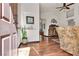 Inviting living area featuring hardwood floors, high ceilings, and large windows at 9562 Collinsleap Ct, Las Vegas, NV 89123