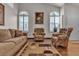Inviting living room featuring bright windows, neutral colors, and comfortable seating at 9562 Collinsleap Ct, Las Vegas, NV 89123