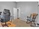 Well-lit office space with a comfortable office chair, hardwood floors and a quaint rocking chair at 9562 Collinsleap Ct, Las Vegas, NV 89123