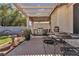 Outdoor patio area with built in grill, dining table and covered shade at 9562 Collinsleap Ct, Las Vegas, NV 89123