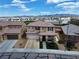 Aerial view of a tan two-story home with a tile roof in a neighborhood with mountain views at 9604 Vital Crest St, Las Vegas, NV 89123