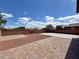 The backyard shows a brick paver patio with gravel accents and perimeter concrete, great for relaxing at 9604 Vital Crest St, Las Vegas, NV 89123