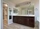 Bathroom features dual sinks, dark cabinets, and a walk-in closet at 9604 Vital Crest St, Las Vegas, NV 89123