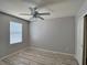 Bedroom featuring neutral walls, wood-look flooring, a closet, ceiling fan, and a window at 9604 Vital Crest St, Las Vegas, NV 89123