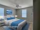 Bedroom featuring neutral walls, wood-look flooring, a ceiling fan, and lake views from the window at 9604 Vital Crest St, Las Vegas, NV 89123