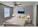 Bedroom with ceiling fan featuring neutral walls, wood-look flooring, closet, and a window at 9604 Vital Crest St, Las Vegas, NV 89123
