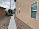 A long concrete pathway leads to a beige two-story home featuring neutral rock landscaping at 9604 Vital Crest St, Las Vegas, NV 89123