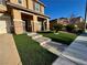 Inviting front yard with stone steps and artificial turf leading to a charming home entrance at 9604 Vital Crest St, Las Vegas, NV 89123