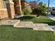 Close-up of stone steps leading to a home's entrance and the artificial turf at 9604 Vital Crest St, Las Vegas, NV 89123