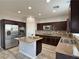Modern kitchen featuring stainless steel appliances, granite countertops, and wood look floors at 9604 Vital Crest St, Las Vegas, NV 89123