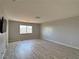 Open living room with plank floors and lots of natural light at 9604 Vital Crest St, Las Vegas, NV 89123