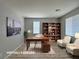 Staged office with desk, chairs, and a bookcase at 9604 Vital Crest St, Las Vegas, NV 89123