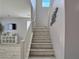 Staircase with a white banister and carpeted steps at 9604 Vital Crest St, Las Vegas, NV 89123