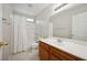 Bright bathroom featuring a vanity with wood cabinetry, a large mirror, and a shower-tub combination at , Las Vegas, NV 89149