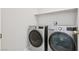 Modern laundry room with side-by-side washer and dryer, and a shelf for efficient storage at , Las Vegas, NV 89149