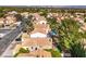 An aerial view of a residential neighborhood showcases well-maintained homes with classic terracotta roofs at 10009 Coral Sands Dr, Las Vegas, NV 89117