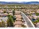 Aerial view of the neighborhood showcasing the tile roofs, landscaping, and proximity to mountains at 10009 Coral Sands Dr, Las Vegas, NV 89117