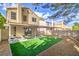 Backyard featuring an artificial lawn, a gravel area, and a covered patio with seating at 10009 Coral Sands Dr, Las Vegas, NV 89117