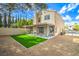 Backyard featuring an artificial lawn, a gravel area, and a covered patio with seating at 10009 Coral Sands Dr, Las Vegas, NV 89117