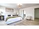Spacious bedroom showcasing wood floors, designer lighting, and an ensuite bathroom at 10009 Coral Sands Dr, Las Vegas, NV 89117