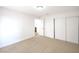 Carpeted bedroom with ample natural light and an ensuite bathroom at 10009 Coral Sands Dr, Las Vegas, NV 89117