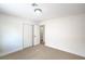Bright bedroom with neutral carpeting, closet, and access to the next room at 10009 Coral Sands Dr, Las Vegas, NV 89117