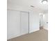 Bright bedroom featuring neutral carpeting and a large closet with sliding doors at 10009 Coral Sands Dr, Las Vegas, NV 89117