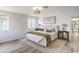 Sunlit bedroom featuring a neutral color scheme, plush rug, and modern decor at 10009 Coral Sands Dr, Las Vegas, NV 89117